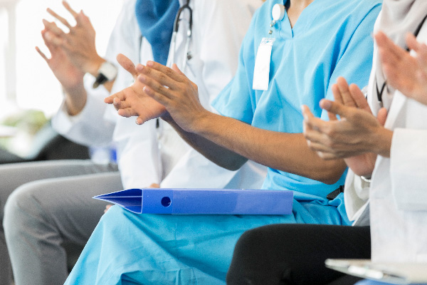Doctors and Nurses clapping at medical conference
