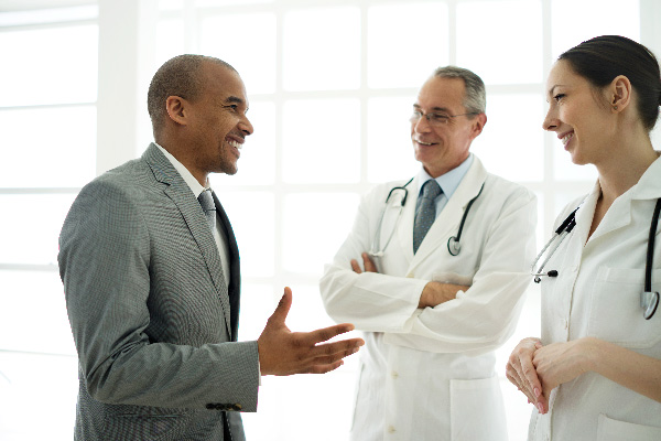 Professional speaking with two doctors