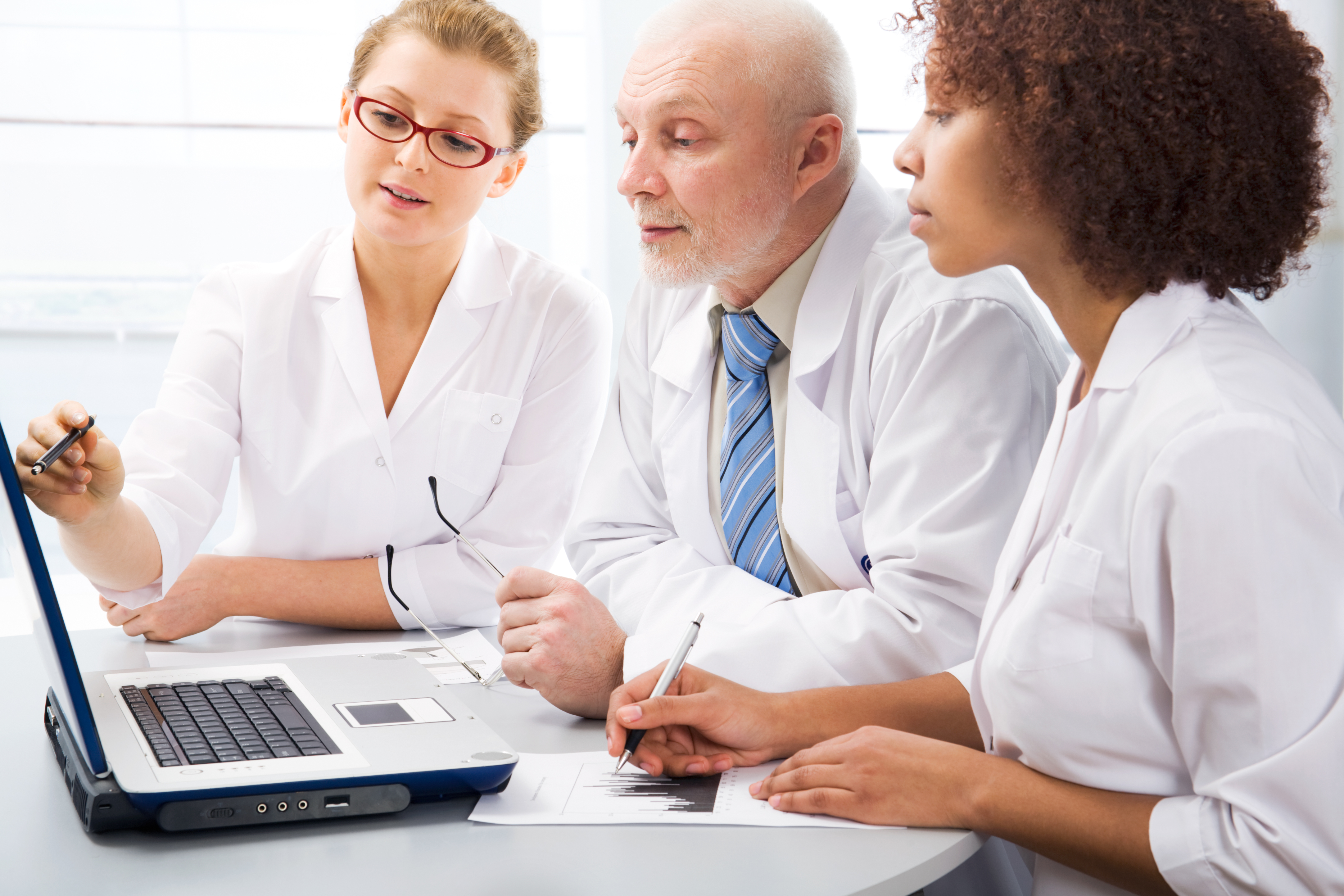 Group of doctors discuss work in an office