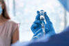 Male Doctor Wearing Gloves Holding Syringe Taking Coronavirus Va