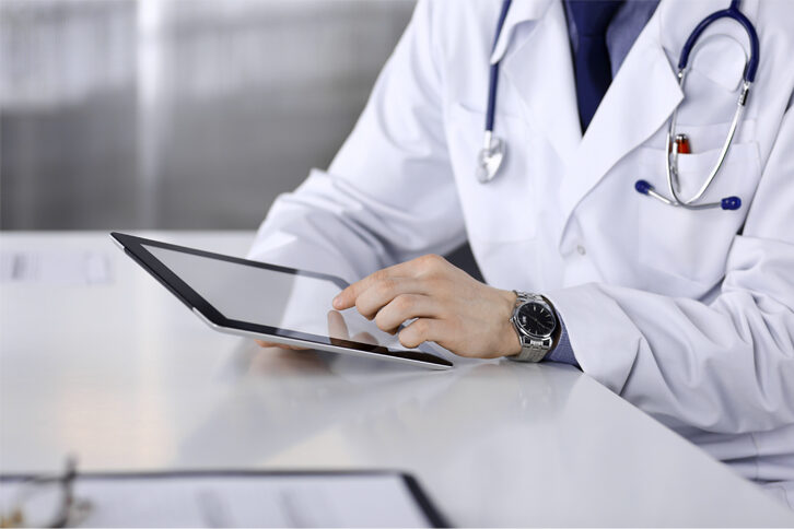 Medical professional on tablet