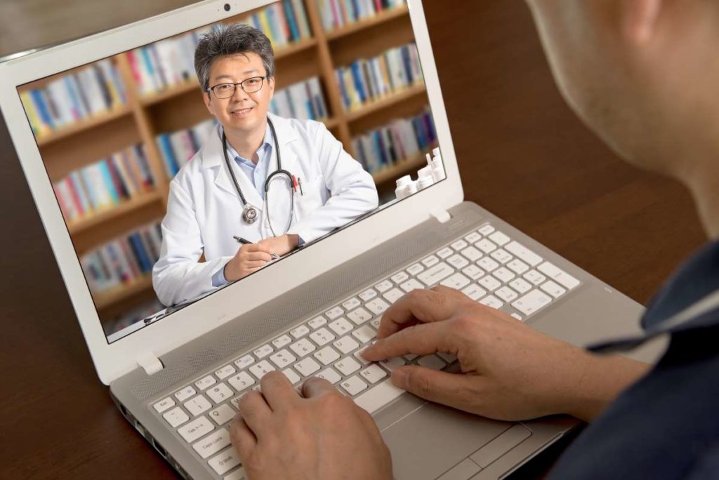 Doctor having telehealth meeting on computer