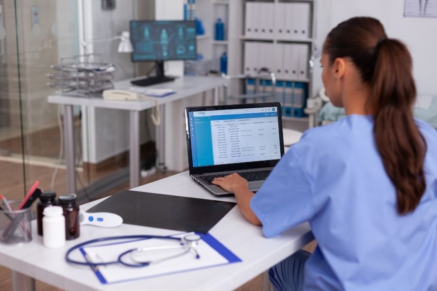 Nurse looking at patient documentation on a laptop